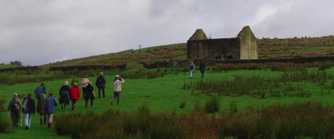 TAG members heading up the hill to Black Middens Bastle House