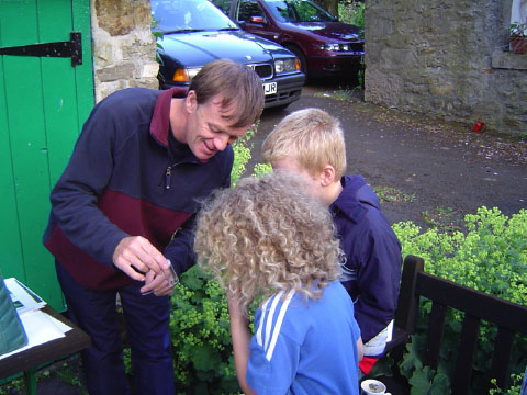 NNPA ranger, Shaun Hackett, showing moths to young enthusiasts
